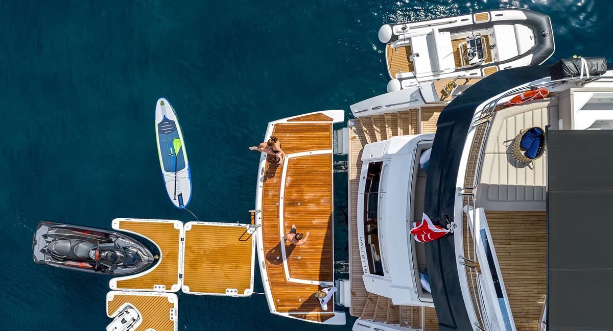 Aerial view of M/Y Lio Black Knight Sunseeker 95 with water toys deployed — yacht charter Balearic Islands