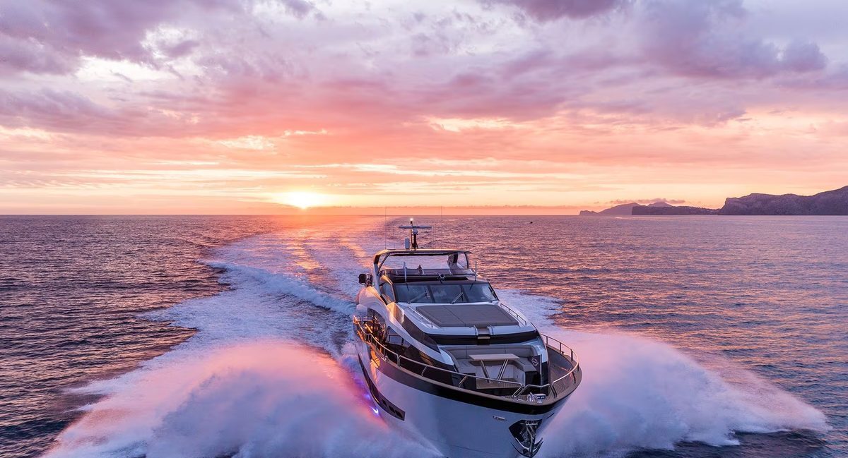 M/Y Lio Black Knight Sunseeker 95 illuminated at sunset with underwater lights — luxury yacht charter Palma de Mallorca