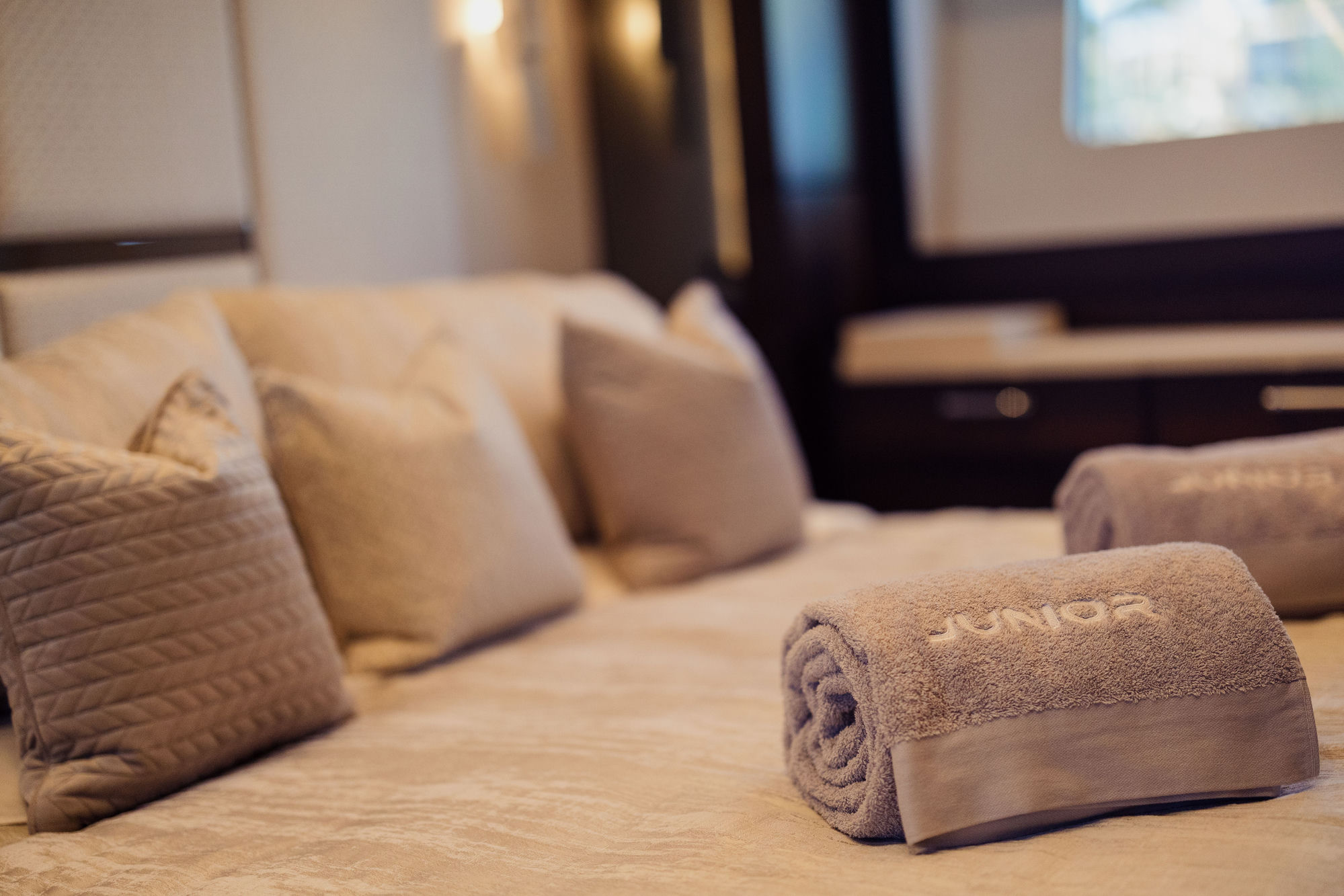 M/Y Lio Black Knight Sunseeker 95 guest cabin with branded towels — luxury charter details