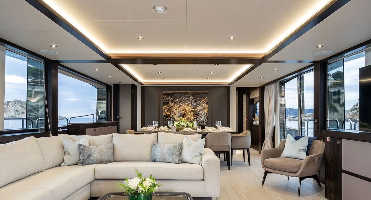 Guest enjoying evening in salon of M/Y Lio Black Knight Sunseeker 95 — luxury charter